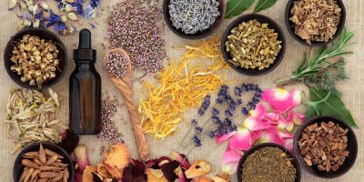 Herbal naturopathic medicine selection also used in pagan witches magical potions over old paper background.